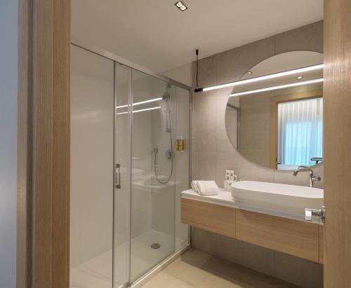 a bathroom with a glass shower and a sink at Zenit Coruña in A Coruña