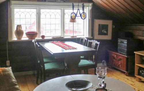 a dining room with a table and a window at Beautiful Home In Leksand With Wifi in Leksand