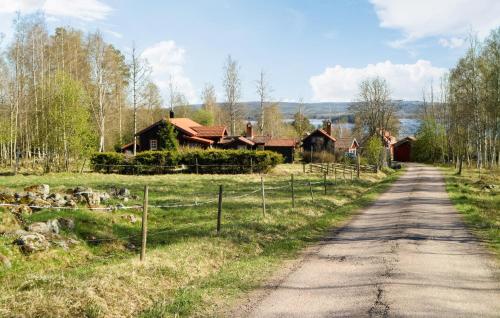 a dirt road in front of a house at Beautiful Home In Leksand With Wifi in Leksand