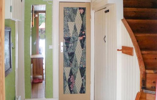 a hallway with a door with a quilt on it at Beautiful Home In Leksand With Wifi in Leksand