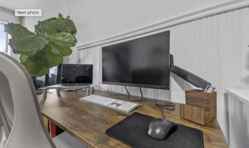 a desk with a computer monitor and a keyboard and mouse at 1 Bedroom Apartment East Village Union Square in New York