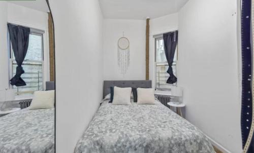 a bedroom with a bed and a mirror at 1 Bedroom Apartment East Village Union Square in New York