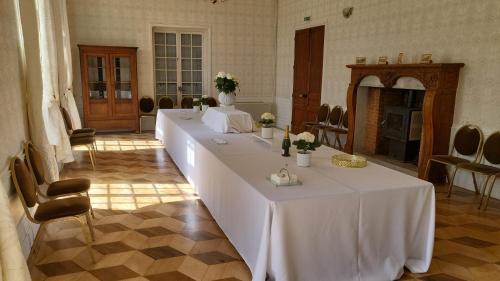 a row of tables in a room with chairs at Château Fédora in Marcilloles