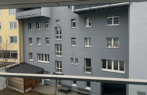 a gray building with windows and a balcony at Hotel Gösser Bräu in Wels