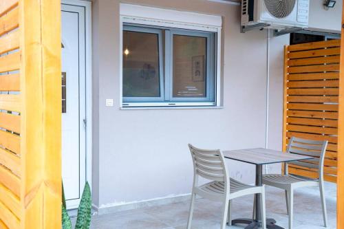 a table and chairs in front of a house at Areston hersonisos apartment in Hersonissos
