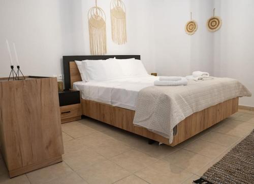 a bedroom with a large bed and a wooden cabinet at Areston hersonisos apartment in Hersonissos
