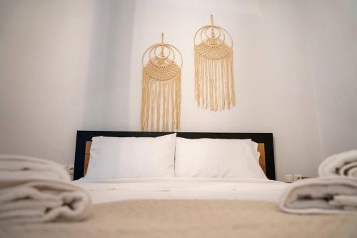 a bedroom with a bed and two hanging baskets at Areston hersonisos apartment in Hersonissos