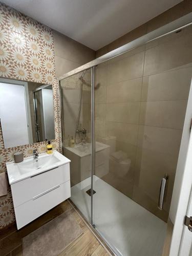 a bathroom with a shower and a sink and a toilet at Benicasim Village by Tucasanlaplaya in Benicàssim