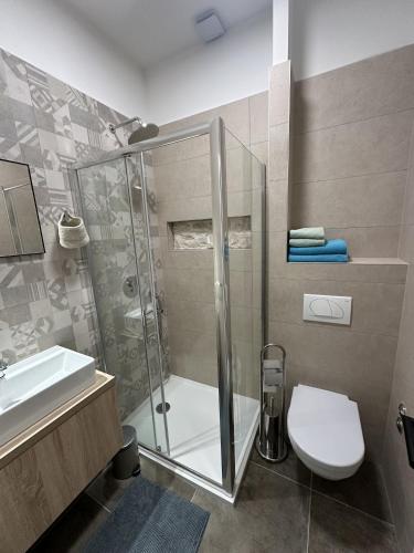 a bathroom with a shower and a toilet and a sink at Apartments Urban in Poreč