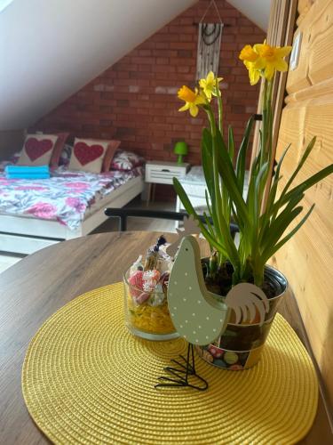 a table with a vase with a plant on it at Panorama Świętokrzyska in Górno