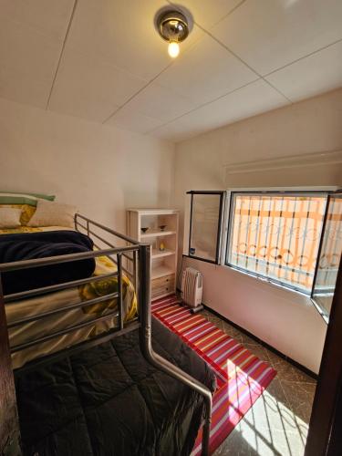 a room with two bunk beds and a window at Montagne vue panoramique sur mer in Pals