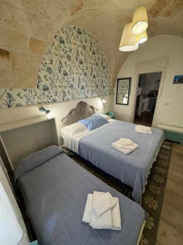 a hotel room with two beds with towels on them at Casa Mida - Guest House in Pezze di Greco