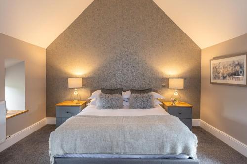 a bedroom with a large bed with two night stands at Fairfield House in Newsham