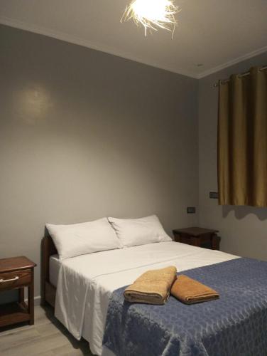een slaapkamer met een bed met twee handdoeken erop bij Atlanticguesthouse in Douaïra