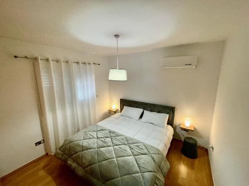 尼科西亞的住宿－La Vie Royale Charming Apartment by Platform 357，一间卧室配有一张带两个灯的床铺