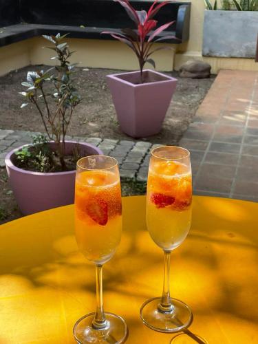 two glasses with fruit in them sitting on a table at Ushas Hotel in Trivandrum