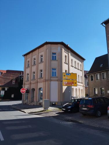 a building with a stop sign next to a street at Stadtblick 1 Monteuersfreud in Eisenberg
