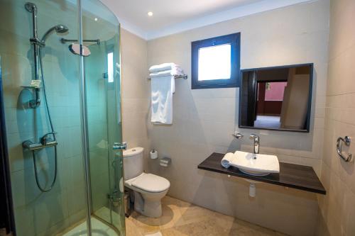 a bathroom with a shower and a toilet and a sink at Oliva Hotel Condominium Marrakech in Marrakesh