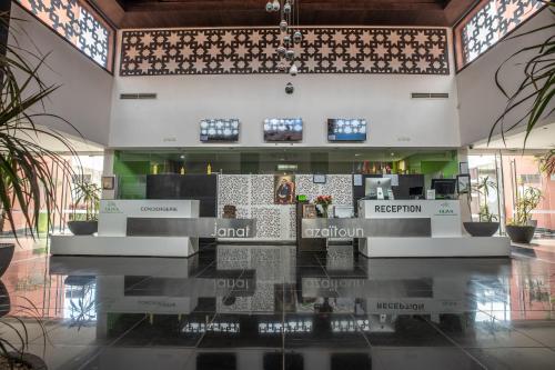 a lobby of a building with a bar in it at Oliva Hotel Condominium Marrakech in Marrakech