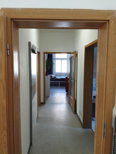 a hallway leading into a living room with doors open at Stadtblick 1 Monteuersfreud in Eisenberg