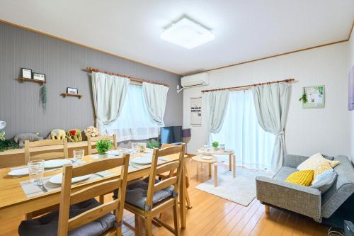 a dining room and living room with a table and chairs at Comfy Home Koiwa in Tokyo