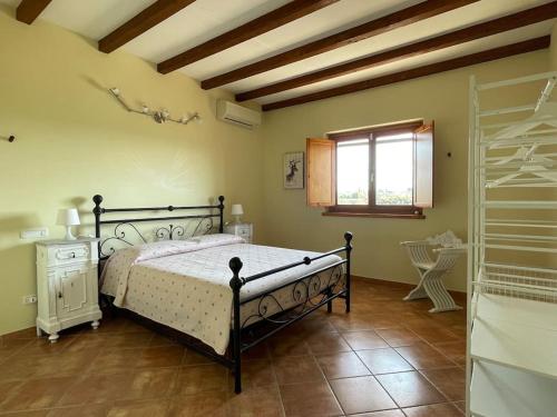 a bedroom with a bed and a window at Tenuta Agave in Ardea