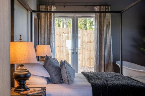 a bedroom with a bed and a large window at Bearskin Cottage in Leyburn
