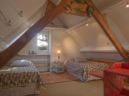 - une chambre mansardée avec 2 lits et une fenêtre dans l'établissement Maison au bord de mer avec jardin paysager, proche port et commerces à Sauzon - FR-1-418-49, à Sauzon