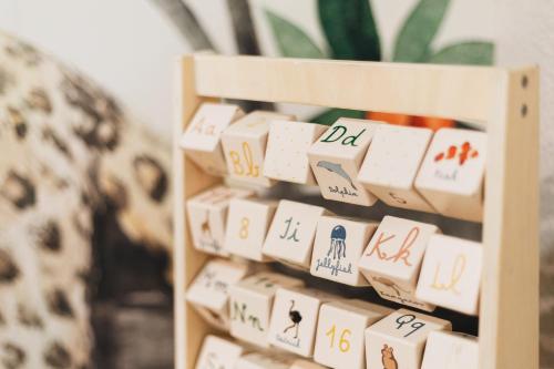 a bunch of dominoes on a wooden shelf at Hotel Malcom and Barret in Valencia