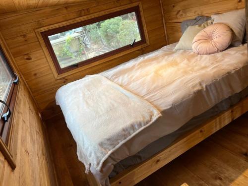 a bedroom with a large bed with a window at In Situ Mar in Pichilemu
