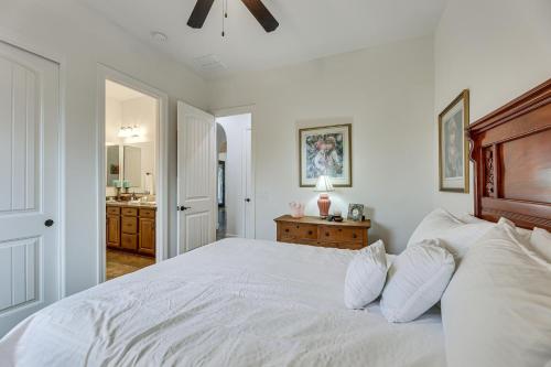 a bedroom with a white bed and a bathroom at Poolside Relaxation Queen Creek Oasis with Fire Pit in Queen Creek