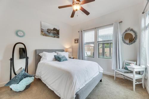 a bedroom with a bed and a ceiling fan at Poolside Relaxation Queen Creek Oasis with Fire Pit in Queen Creek