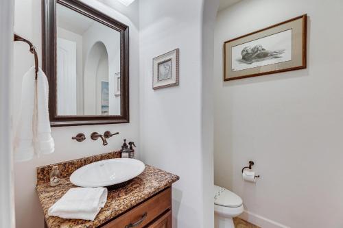 a bathroom with a sink and a toilet at Poolside Relaxation Queen Creek Oasis with Fire Pit in Queen Creek