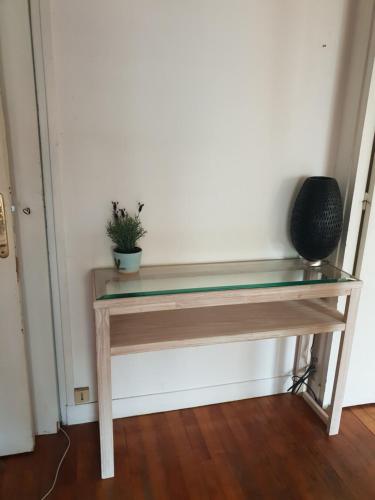 a desk with a glass top and a plant on it at PARIS 75013 - petite Chambre lumineuse dans une colocation de 3 bien située proche TRAM RER B et métros in Paris
