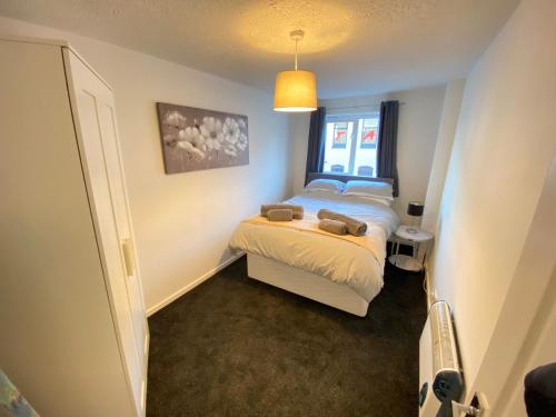 a small bedroom with a bed and a window at 2 Bedroom Modern Apartment in Earl Shilton