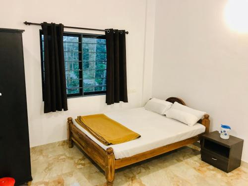 a small bed in a room with a window at Hotel Chef Knife (Part of Querencia Precinct) in Gonikoppal