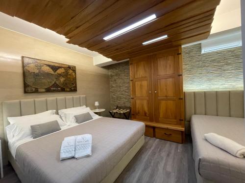 a bedroom with two beds and a couch in it at Villa Carly Taormina apartment with private pool in Trappitello