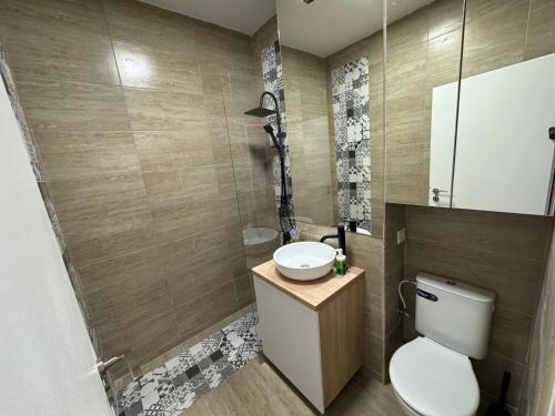 a bathroom with a toilet and a sink at Miraculous Luxury Apartment in Bucharest