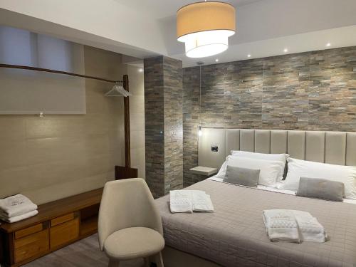 a bedroom with a bed and a desk and a chair at Villa Carly Taormina apartment with private pool in Trappitello
