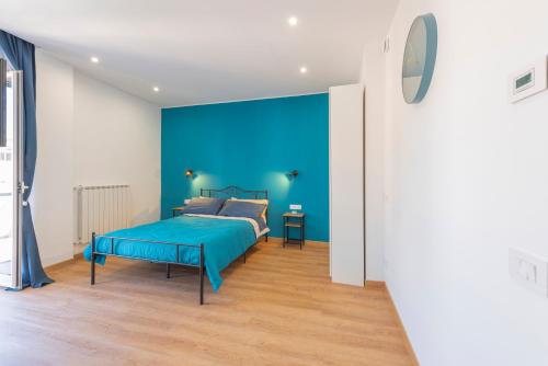 a blue bedroom with a bed and a blue wall at Casetta Tuscolana in Rome