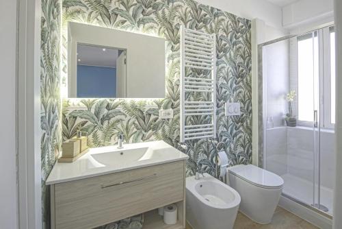 a bathroom with a sink and a toilet and a mirror at Casetta Tuscolana in Rome