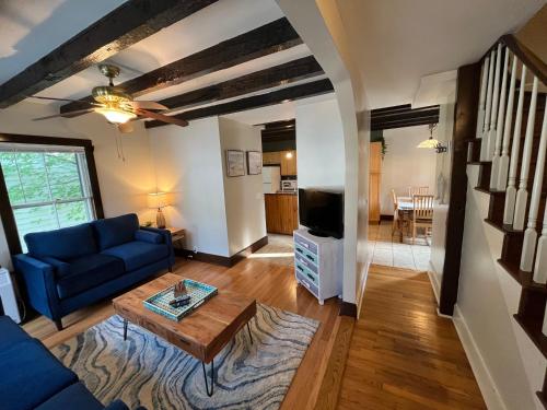 a living room with a blue couch and a table at Cozy 3BR Beach House by the Sea in Old Orchard Beach