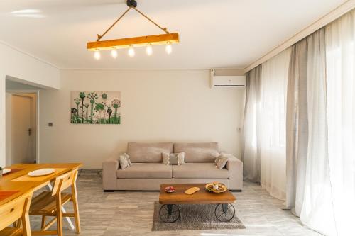 a living room with a couch and a table at AcroLofts M62 in Athens