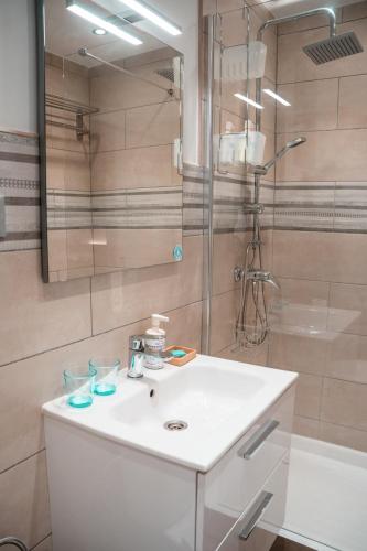 a bathroom with a white sink and a shower at Villa Lajares Red House Fuerteventura in Lajares