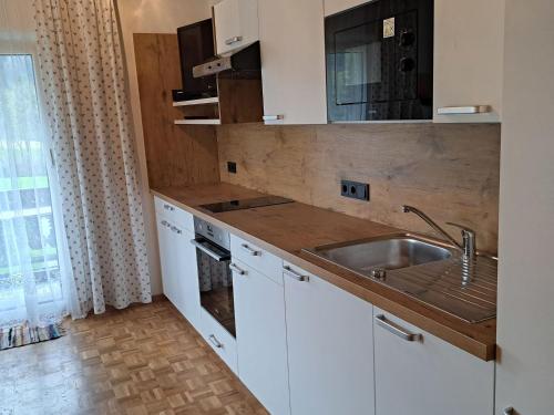 a kitchen with a sink and a counter top at Apartment Fichte by Interhome in Oberwang