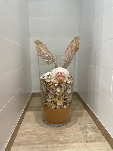 a vase with a shell and a plant in it at Villa Carly Taormina apartment with private pool in Trappitello