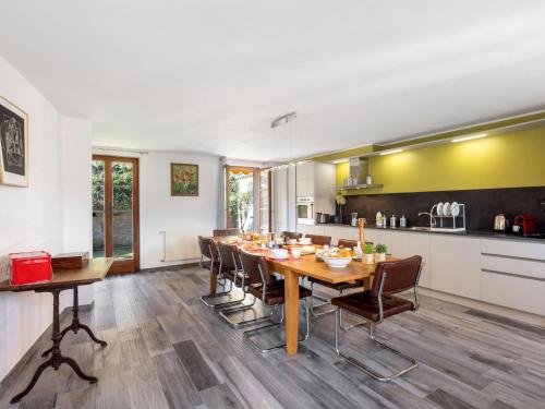 a kitchen and dining room with a table and chairs at Holiday Home Casa Dumont by Interhome in Manno