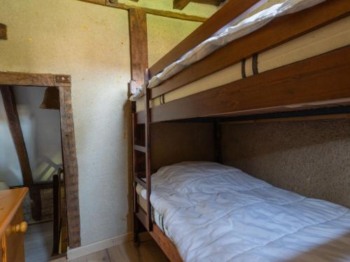 a bedroom with two bunk beds with white sheets at Holiday Home Le Moulin by Interhome in Fons