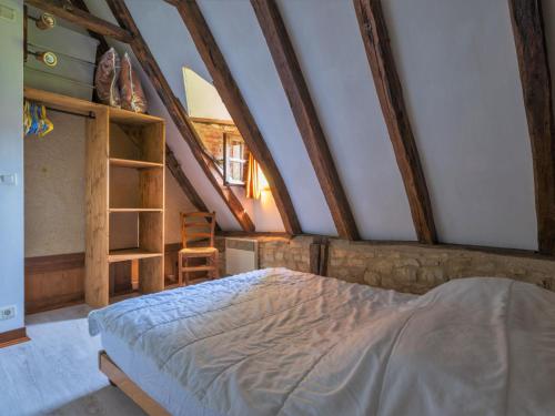 a bedroom in an attic with a bed in it at Holiday Home Le Moulin by Interhome in Fons