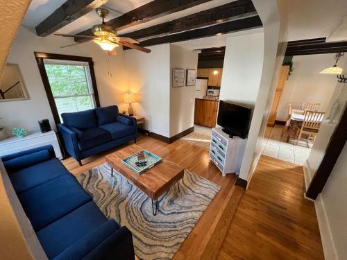 a living room with a blue couch and a table at Cozy 3BR Beach House by the Sea in Old Orchard Beach
